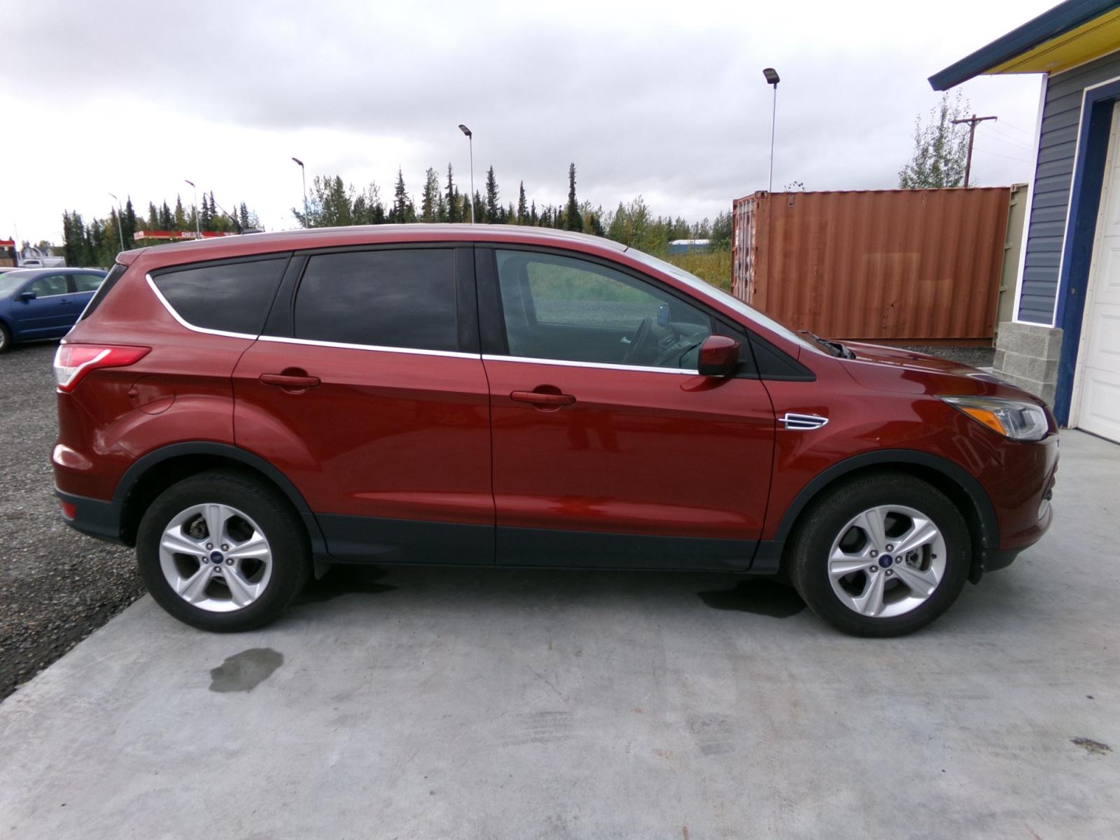 2015 Orange Ford Escape SE 4WD (1FMCU9G9XFU) with an 2.0L L4 DOHC 16V engine, 6-Speed Automatic transmission, located at 2630 Philips Field Rd., Fairbanks, AK, 99709, (907) 458-0593, 64.848068, -147.780609 - Photo #2