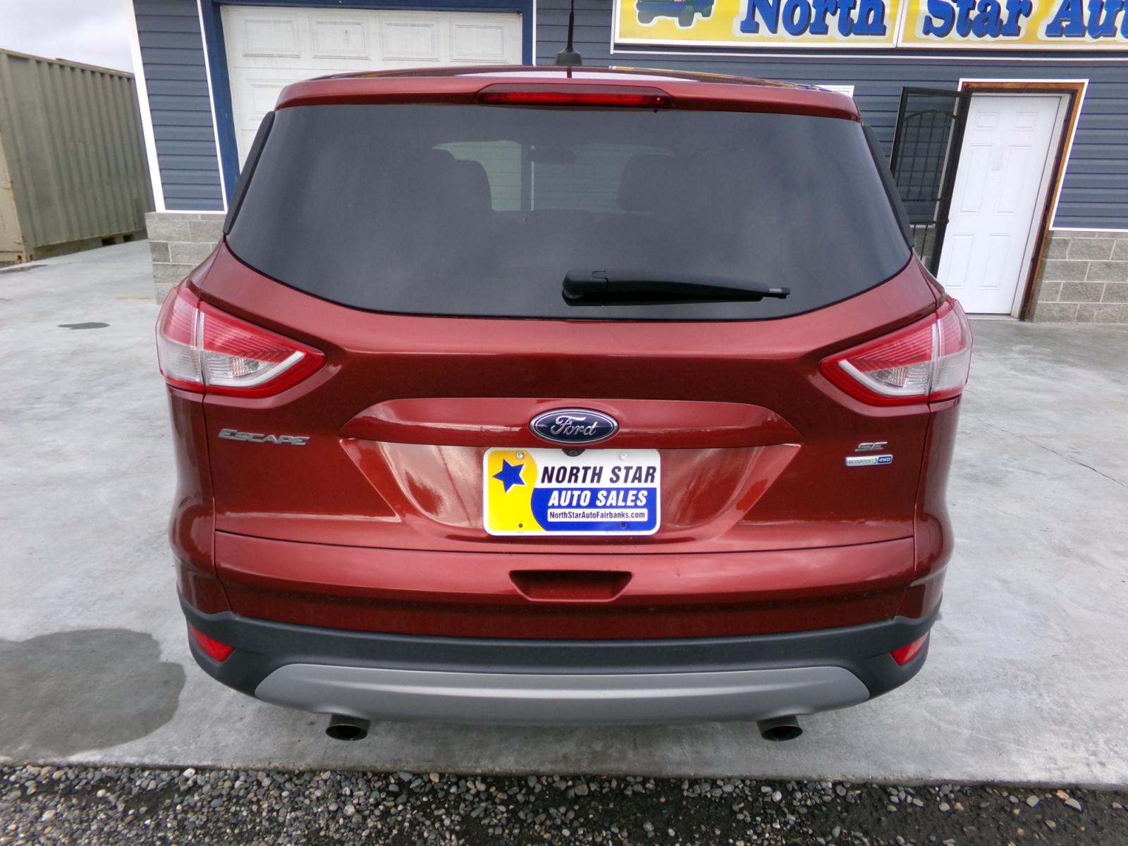2015 Orange Ford Escape SE 4WD (1FMCU9G9XFU) with an 2.0L L4 DOHC 16V engine, 6-Speed Automatic transmission, located at 2630 Philips Field Rd., Fairbanks, AK, 99709, (907) 458-0593, 64.848068, -147.780609 - Photo #3