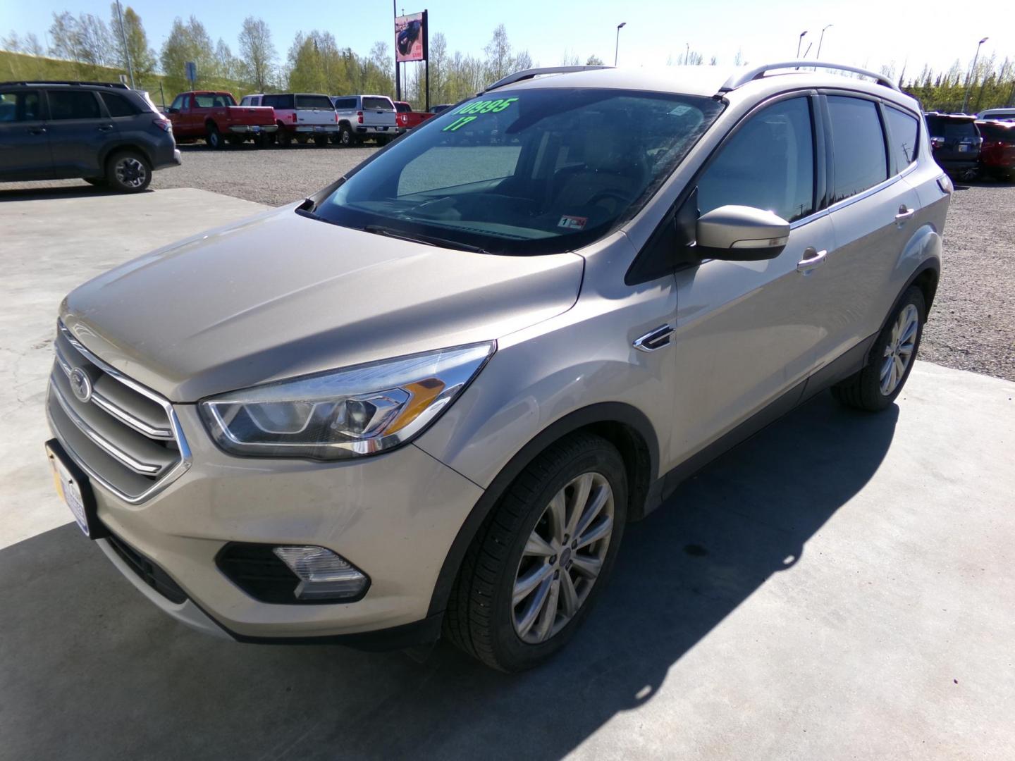2017 Gold Ford Escape Titanium FWD (1FMCU0J96HU) with an 2.0L L4 DOHC 16V engine, 6A transmission, located at 2630 Philips Field Rd., Fairbanks, AK, 99709, (907) 458-0593, 64.848068, -147.780609 - Photo#0