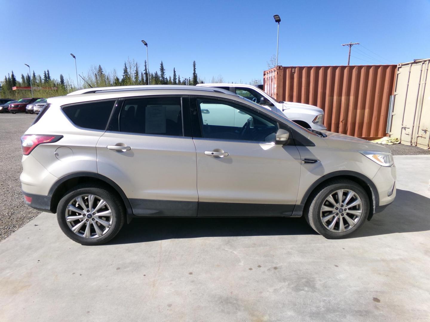 2017 Gold Ford Escape Titanium FWD (1FMCU0J96HU) with an 2.0L L4 DOHC 16V engine, 6A transmission, located at 2630 Philips Field Rd., Fairbanks, AK, 99709, (907) 458-0593, 64.848068, -147.780609 - Photo#2