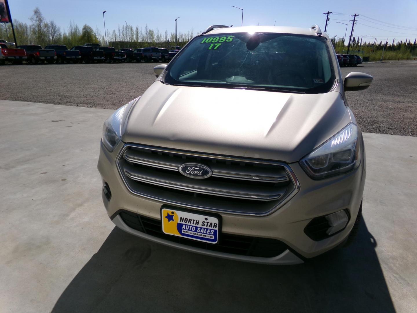 2017 Gold Ford Escape Titanium FWD (1FMCU0J96HU) with an 2.0L L4 DOHC 16V engine, 6A transmission, located at 2630 Philips Field Rd., Fairbanks, AK, 99709, (907) 458-0593, 64.848068, -147.780609 - Photo#1