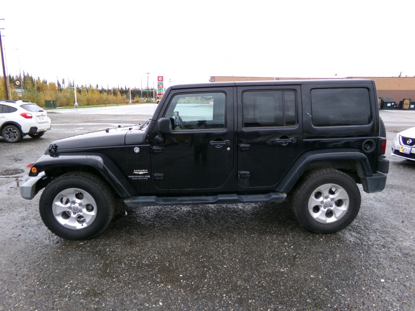 2014 Black Jeep Wrangler Unlimited Sahara 4WD (1C4BJWEG1EL) with an 3.6L V6 DOHC 24V FFV engine, 6-Speed Manual transmission, located at 2630 Philips Field Rd., Fairbanks, AK, 99709, (907) 458-0593, 64.848068, -147.780609- Photo#2